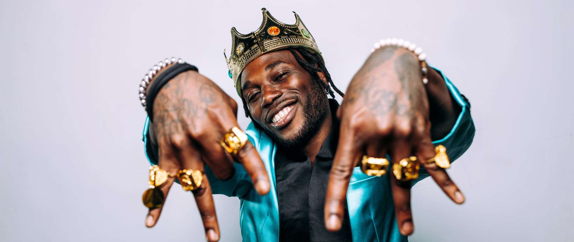 portrait of an hip hop music musician. Cinematic image of a man wearing party clothes and jewels